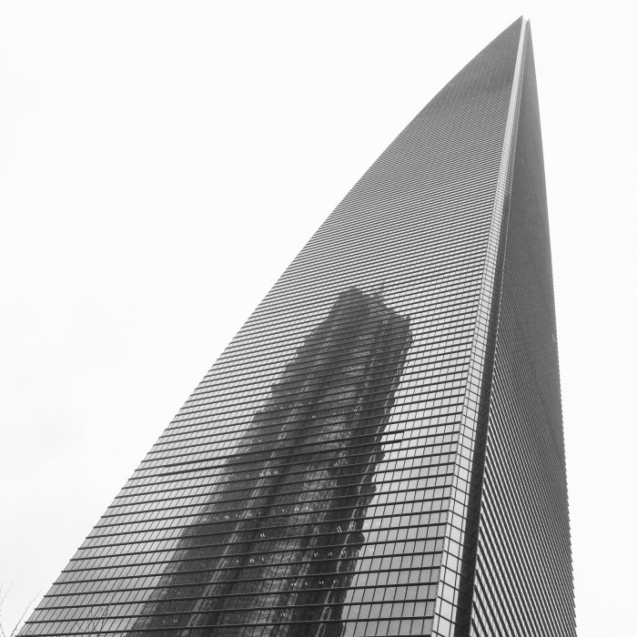 The once-dominating Jin Mao tower's reflection can be seen on the larger Shanghai World Financial Center.