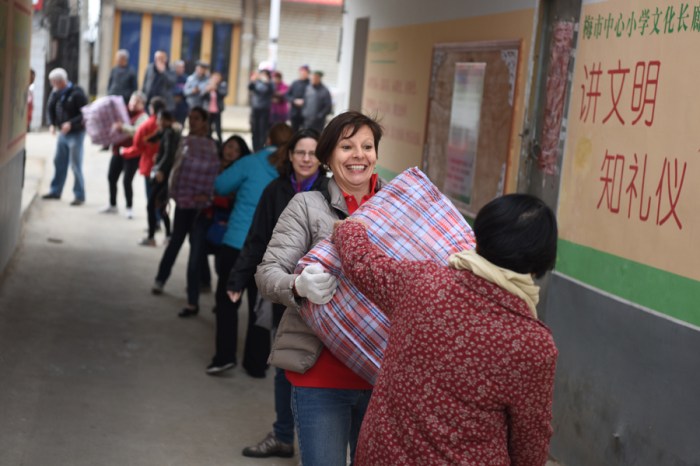 At each school, we quickly formed a chain to unload donation bags full of clothing, toys, and toiletries for school children and their families. 