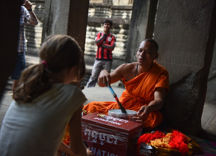 Kate receiving a Buddhist blessing.