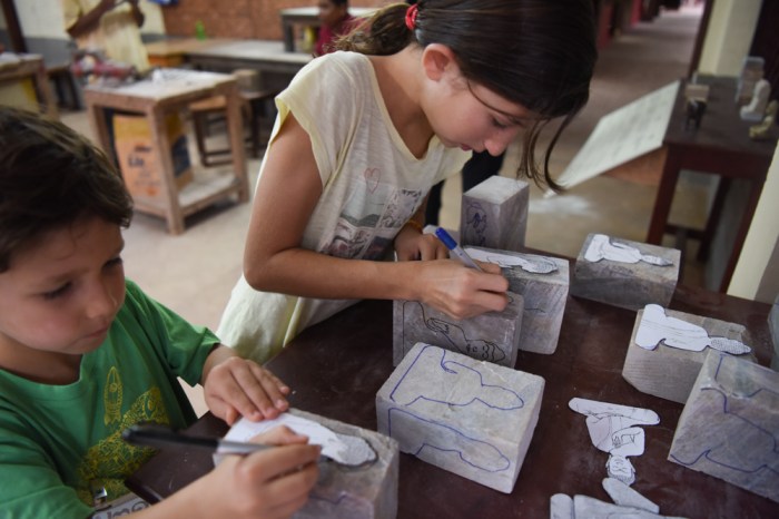 Helping pattern the soapstone for carving.